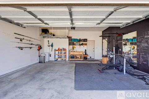 A spacious garage with a workbench and tools.