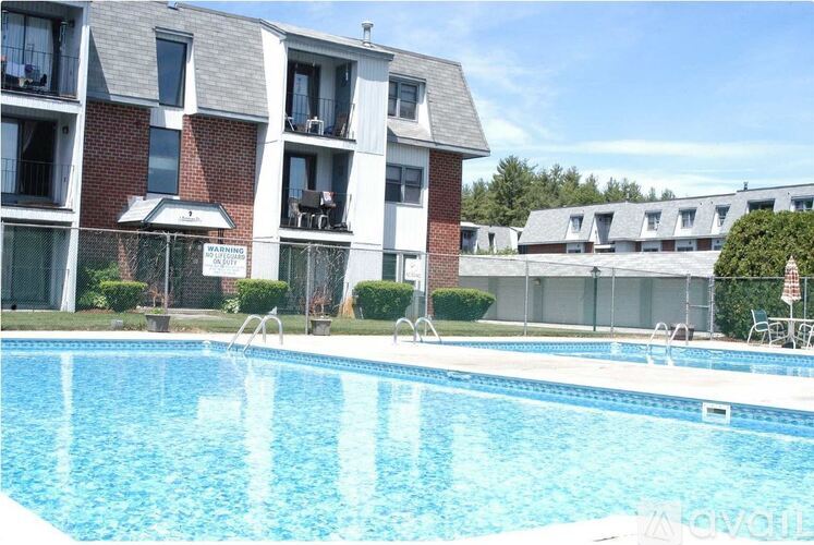 A swimming pool in front of apartment buildings.