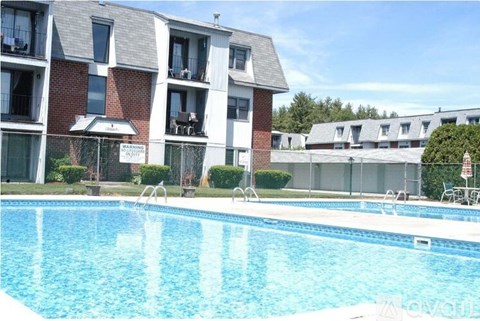 A swimming pool in front of apartment buildings.