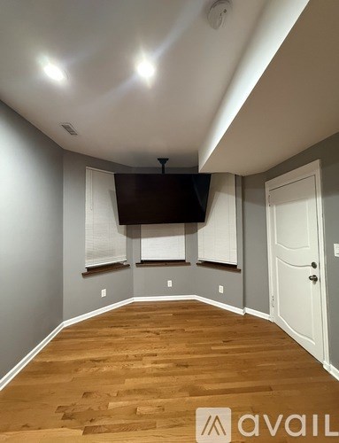 A room with wooden floors and a white door.