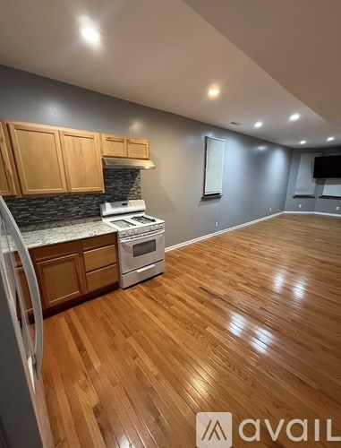 A kitchen with wooden cabinets and a white fridge.