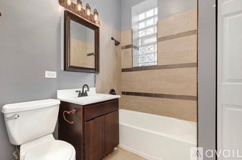 A bathroom with a white toilet and a wooden vanity.