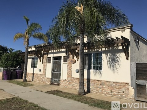 A house with a palm tree in front of it.