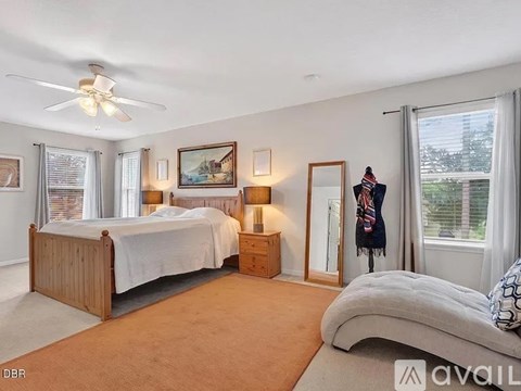A bedroom with a large bed and a smaller bed in the corner.