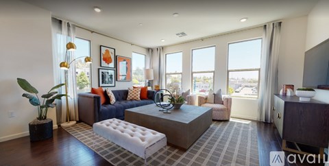 A living room with a large couch and a coffee table.