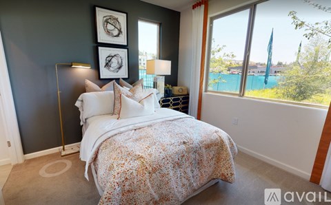A bedroom with a large bed and a view of the outside.