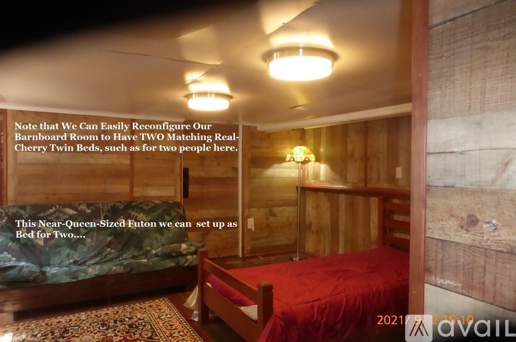 A bedroom with a red bed and a note about reconfiguring the room for two beds.
