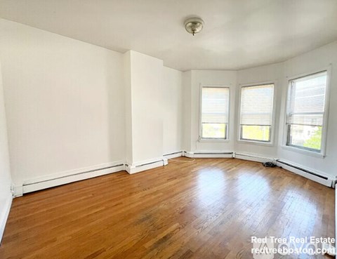 A room with wooden floors and white walls.