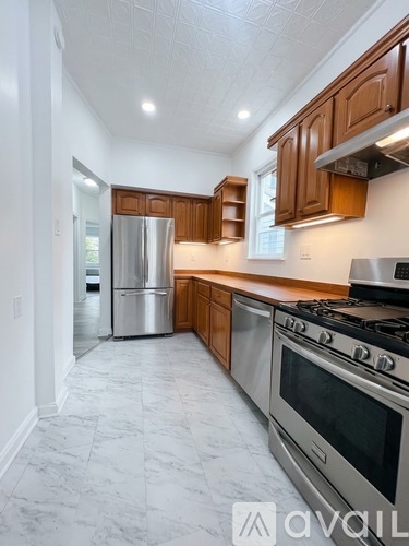 A kitchen with a stove top oven and a refrigerator.