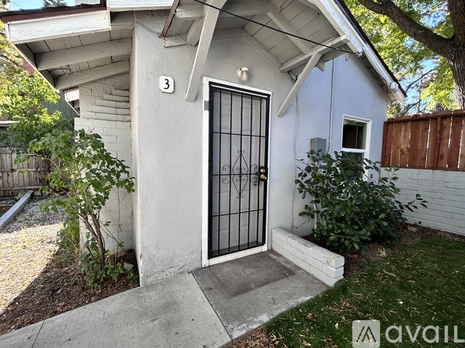 A house with a brown door and a window is for sale.