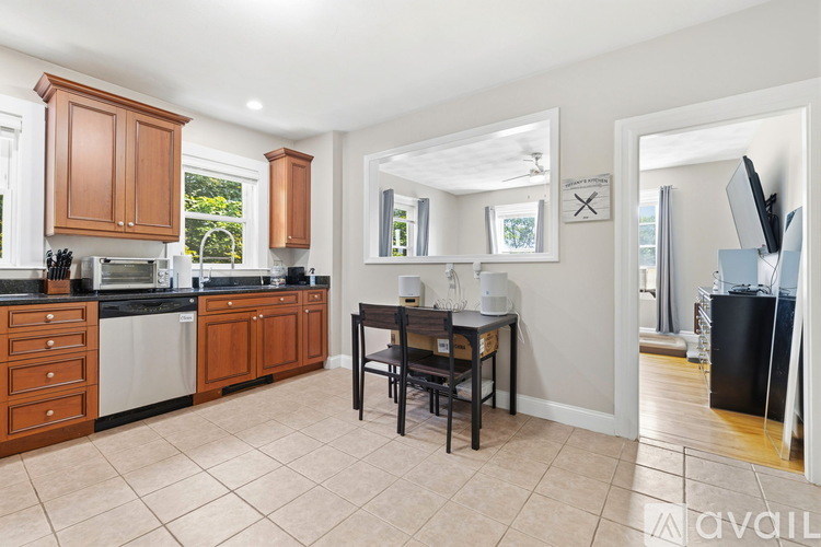 A kitchen with wooden cabinets and a black countertop.