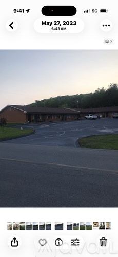 A parking lot with a building in the background.