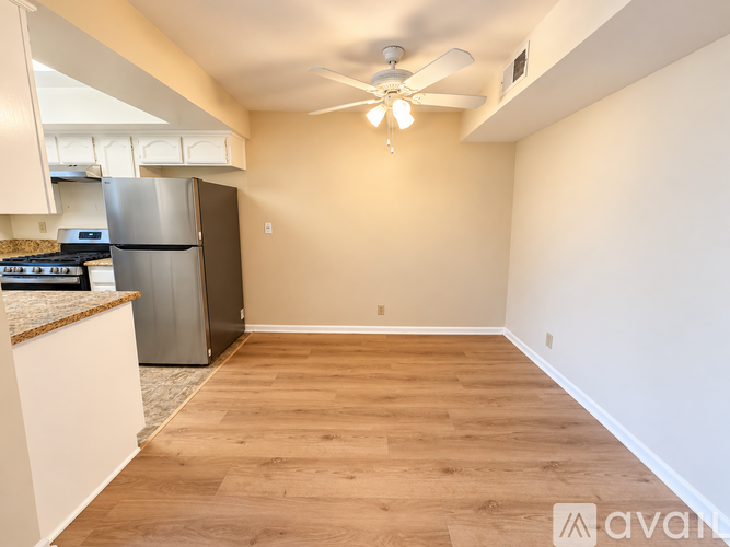 A kitchen with a refrigerator, stove, and oven.