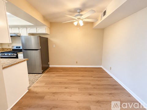 A kitchen with a refrigerator, stove, and oven.