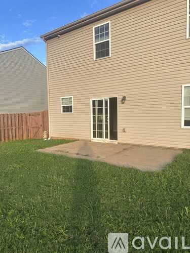 A house with a brown siding and a brown fence.