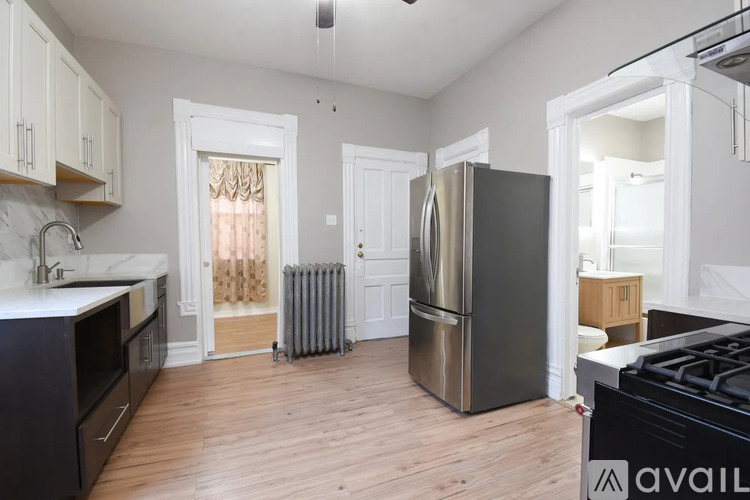 A kitchen with a black stove top oven and a black fridge.