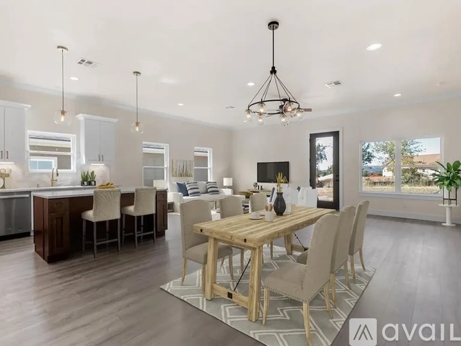 A modern dining room with a wooden table and chairs.