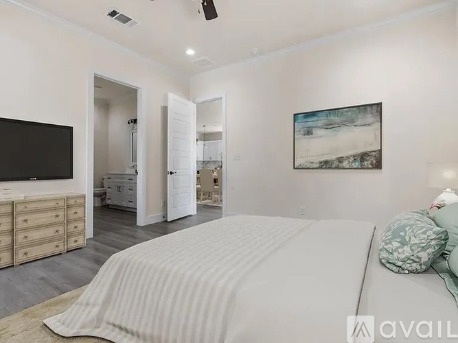 A bedroom with a large bed and a television.