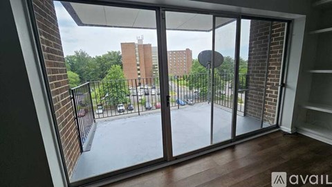 A balcony with a view of a street and buildings.