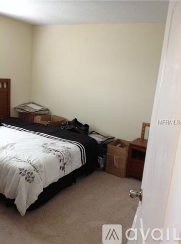 A bedroom with a bed, dresser, and a door with a sign that says "available".