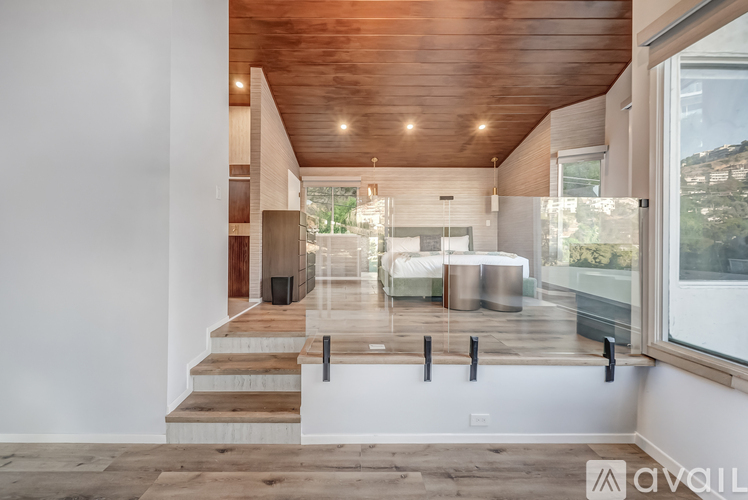 A modern interior space with a wooden ceiling and a glass wall.