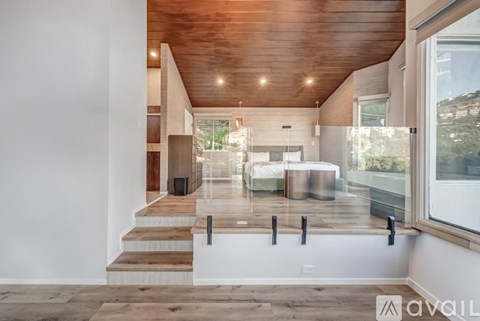 A modern interior space with a wooden ceiling and a glass wall.