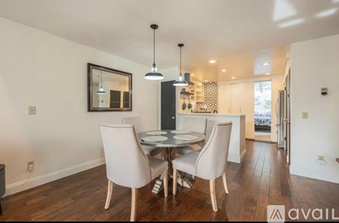 A dining room with a table and chairs.