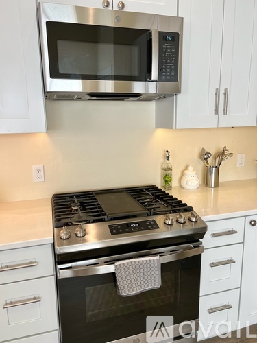 A stainless steel oven with a microwave above it in a kitchen.