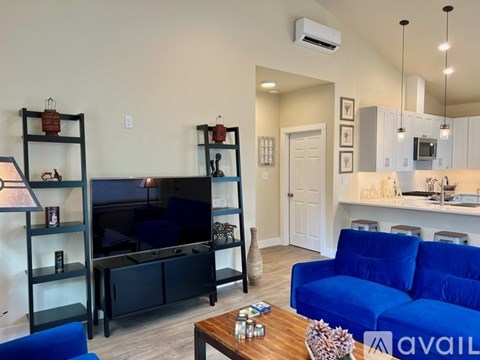 A living room with a blue couch and a television.