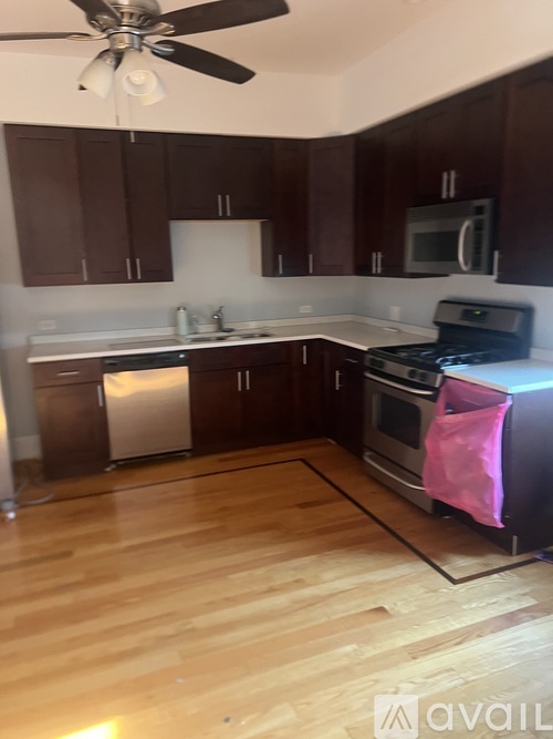 A kitchen with wooden cabinets and a black stove top oven.