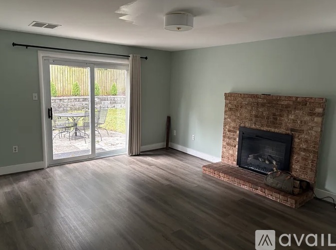 A living room with a fireplace and sliding glass doors.