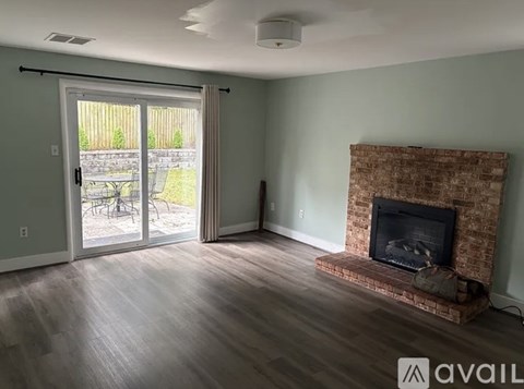 A living room with a fireplace and sliding glass doors.