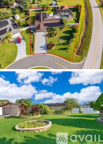 A house with a red fence and a garden in front.