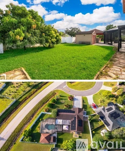 A house with a large lawn and a driveway.