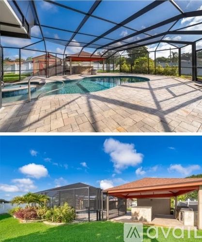 A swimming pool under a glass roof and a covered patio area.