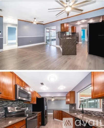 A modern kitchen with wooden cabinets and a black refrigerator.