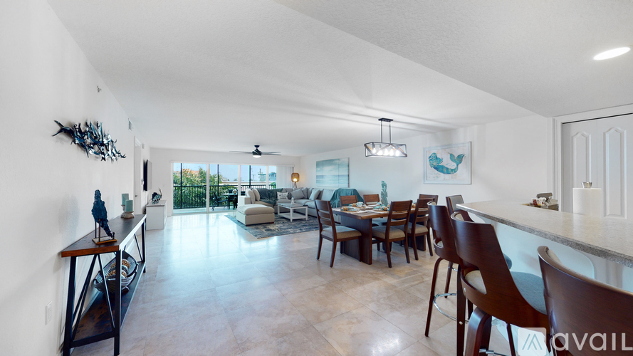 A modern kitchen with a dining table and chairs.