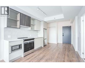 A modern kitchen with white cabinets and stainless steel appliances.