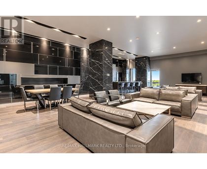 A modern living room with a large sectional sofa and a dining table.