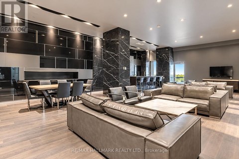 A modern living room with a large sectional sofa and a dining table.