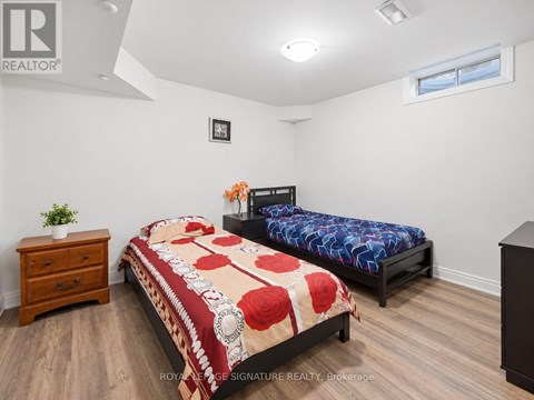A bedroom with a bed, a nightstand, and a dresser.