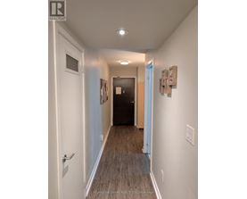 A hallway with a door on the left and a door on the right.