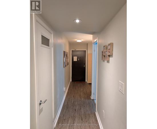 A hallway with a door on the left and a door on the right.