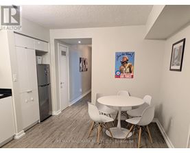 A dining room with a white table and chairs.