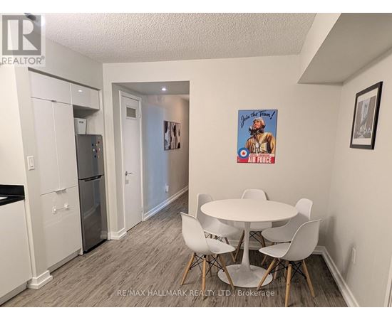 A dining room with a white table and chairs.