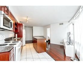 A kitchen with white appliances and a white stove top oven.