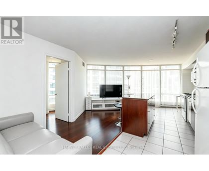 A living room with a white couch and a television.