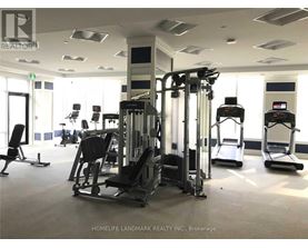 A gym with a variety of equipment including treadmills, weights, and exercise machines.