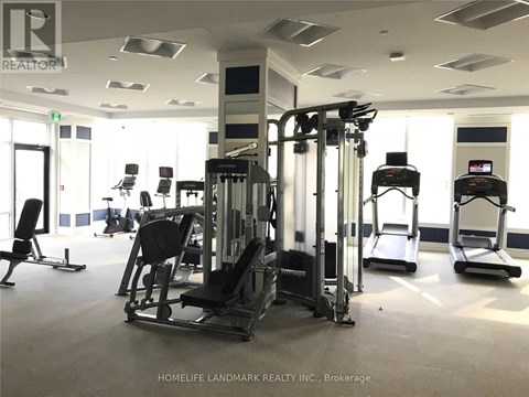 A gym with a variety of equipment including treadmills, weights, and exercise machines.