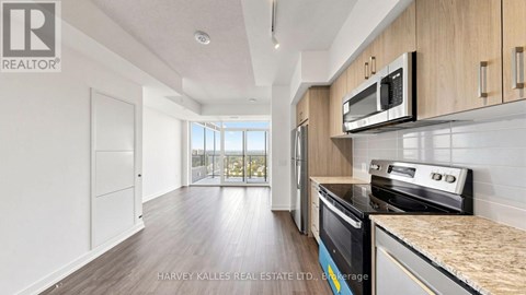 A kitchen with a microwave above the stove.